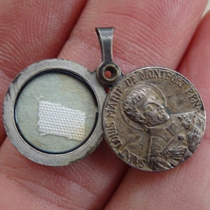 Religious antique French catholic slider locket medal shrine pendant medallion with relic Saint Louis de Montfort and Holy Virgin Mary.  31