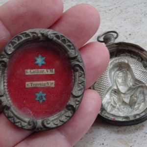 Religious antique French silver plated reliquary medal shrine pendant with relic of Saint Teresa of Avila and Saint Catherine. ( T 35 )