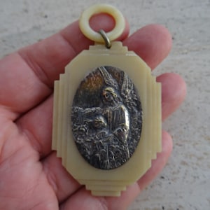 Religious antique French catholic bakelite Art Deco cradle medal medallion pendant of cherub Guardian Angel Raphael protecting a child. K 32