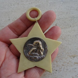 Religious antique French catholic bakelite Art Deco cradle medal charm medallion pendant of a cherub Guardian Angel Raphael. K 53