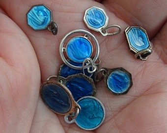 May include: A selection of small, vintage religious pendants in various shapes, including octagons and circles. The pendants have a silver-tone metal frame and are filled with shades of blue enamel. Some pendants have a loop for attaching to a chain.