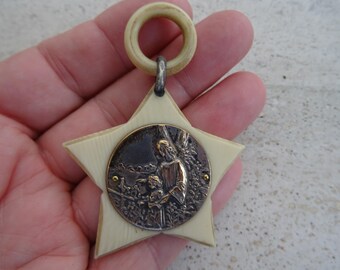 Religious antique French catholic bakelite Art Deco cradle medal charm medallion pendant of a cherub Guardian Angel Raphael. ( K 3 )