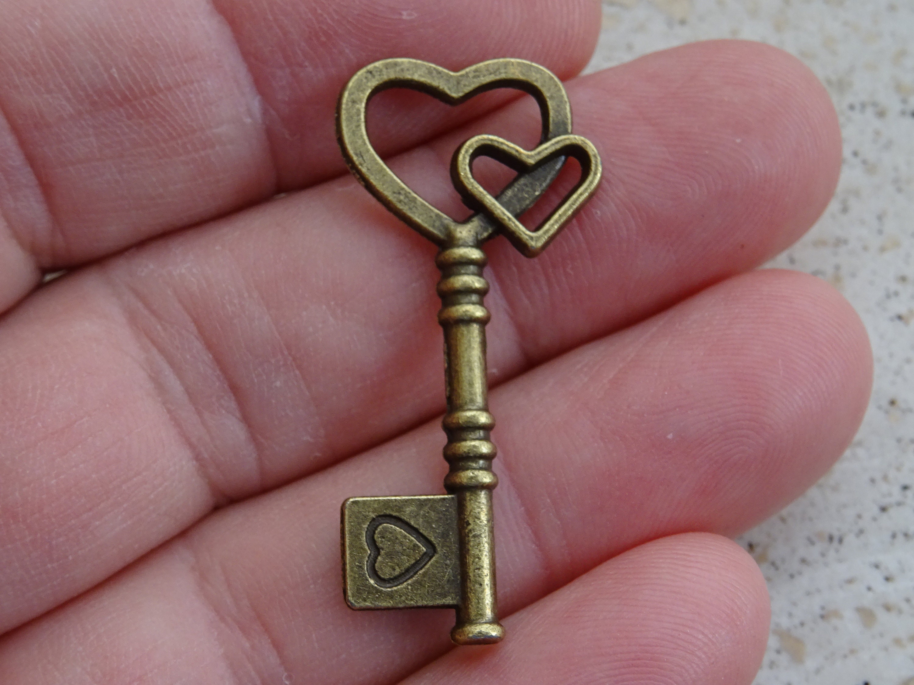 French Bronze Key Charm Pendant Brass Skeleton Key with heart to open a heart. ( A 17 )