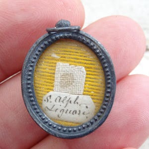 Religious antique French silvered shrine theca medal with relic of Saint Alphonse Alphonsus Marie Liguori. ( P 1a )
