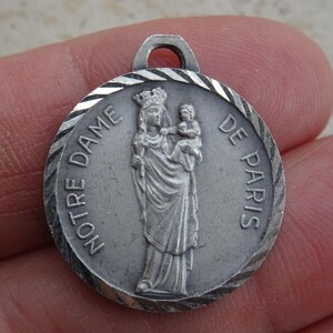 Religious silvered catholic medal pendant Holy charm medallion of Holy Virgin Mary souvenir of Notre Dame de Paris. ( 1)