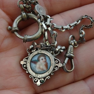 Religious antique silver plated French chatelaine pocket watch chain with medal pendant charm of  an angel cherub Saint Raphael . B 2