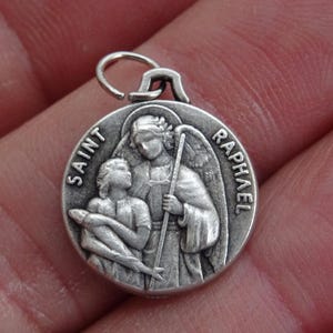Religious vintage silver plated catholic medal pendant charm medallion of guardian angel Saint Raphael. ( A 2 )