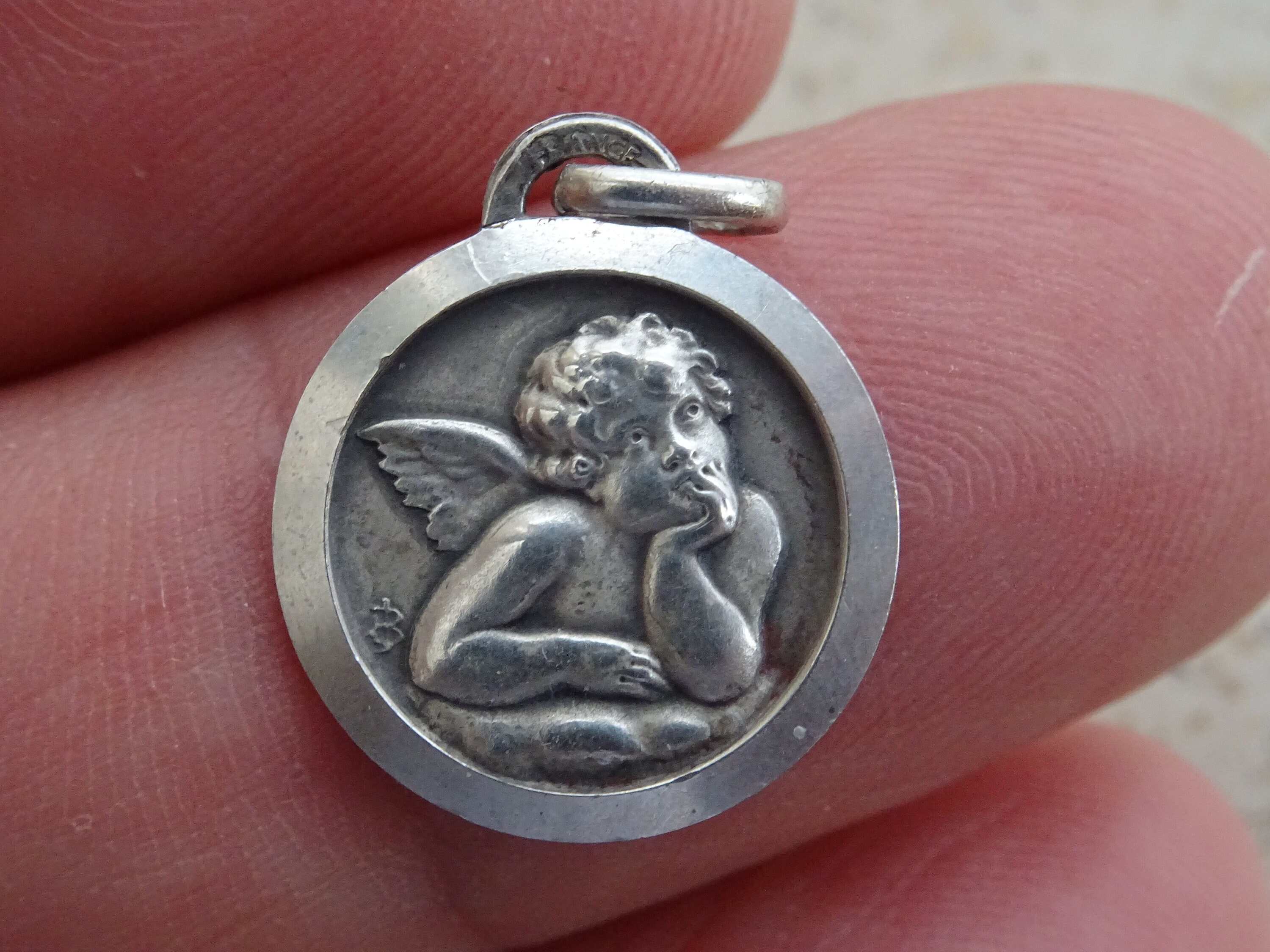 Religious antique silver catholic medal medallion charm pendant of a guardian angel cherub Raphael. (  6 )