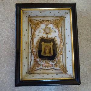Antiguo santuario religioso de madera con reliquia de la Tierra Santa, el Santo Sudario de Turín, de cera, de Jesucristo y de la Santísima Virgen María. Altura 6 cm.