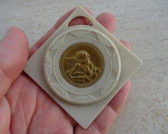 Religious antique French catholic bakelite Art Deco cradle medal charm medallion pendant of a cherub Guardian Angel Raphael. K 35