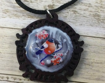 Christmas robin necklace--holiday necklace with 3D bird, greenery, and hand-painted snow in a wooden setting.