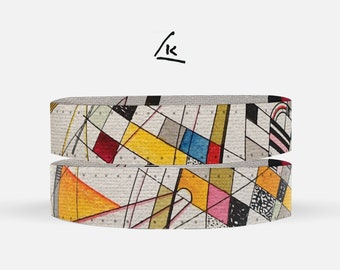 May include: Two rolls of colorful patterned washi tape with geometric designs in yellow, red, blue, black, and white.