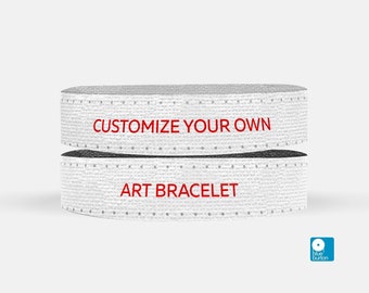 May include: White fabric bracelet with red text that reads "CUSTOMIZE YOUR OWN" and "ART BRACELET".