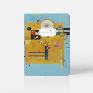 May include: A blue notebook with a yellow, orange, and red abstract painting on the cover. The painting features circles, squares, and lines. The notebook has the word "NOTES" printed on the cover.