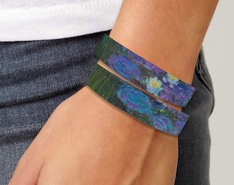 May include: A pair of colorful fabric wristbands with a floral pattern. The wristbands are worn on a person's wrist.