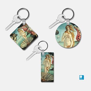 May include: Three keychains featuring different versions of the famous Birth of Venus painting by Sandro Botticelli. Each keychain has a silver key ring and a different shaped charm with a colorful image of the painting.