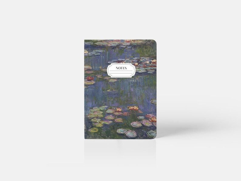 May include: A small notebook with a blue and green water lily design. The cover features a white label with the word "NOTES" printed in black.