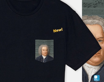 May include: A black t-shirt with a pocket featuring a portrait of Johann Sebastian Bach. The text "New!" is printed in yellow on the shirt.