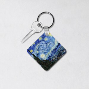 May include: A silver key chain with a square-shaped charm featuring a reproduction of Vincent van Gogh's "Starry Night" painting.