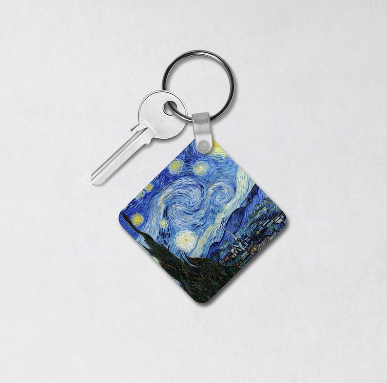 May include: A silver key chain with a square-shaped charm featuring a reproduction of Vincent van Gogh's "Starry Night" painting.