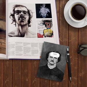 May include: A gray notebook with a black and white image of Edgar Allan Poe on the cover. The notebook has a white label on the front that says "NOTES".