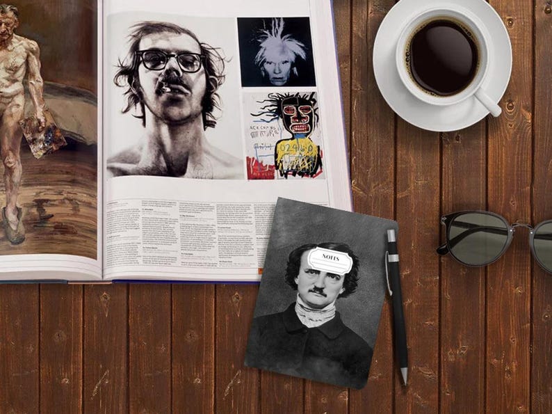 May include: A gray notebook with a black and white image of Edgar Allan Poe on the cover. The notebook has a white label on the front that says "NOTES".