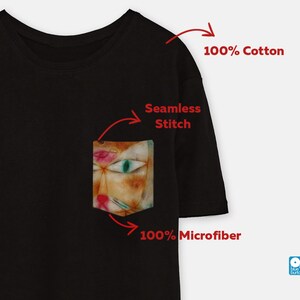 May include: Black t-shirt with a pocket featuring a colourful abstract cat illustration. The t-shirt is made of 100% cotton and the pocket is made of 100% microfiber. The t-shirt has a seamless stitch.