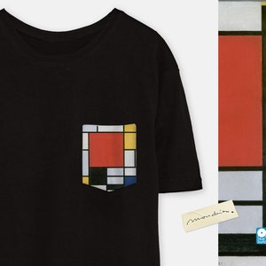 May include: Black t-shirt with a pocket featuring a geometric design in red, yellow, blue, and black. The design is reminiscent of a Mondrian painting. The t-shirt has a tag that says "Mondrian".