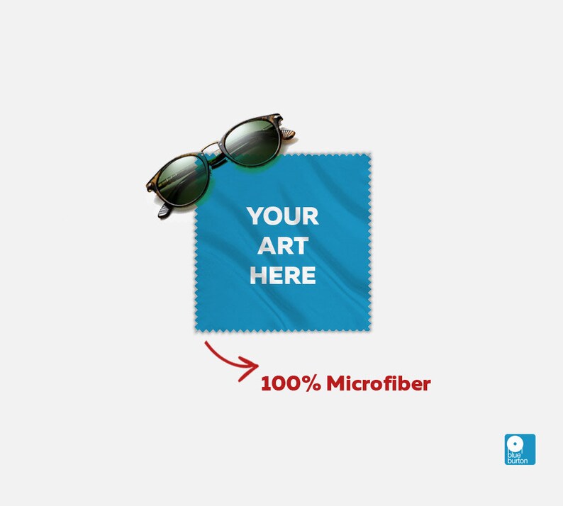 May include: Blue microfiber cleaning cloth with the text "YOUR ART HERE" printed on it. A pair of sunglasses is on top of the cloth. The text "100% Microfiber" is written below the cloth with an arrow pointing to it.