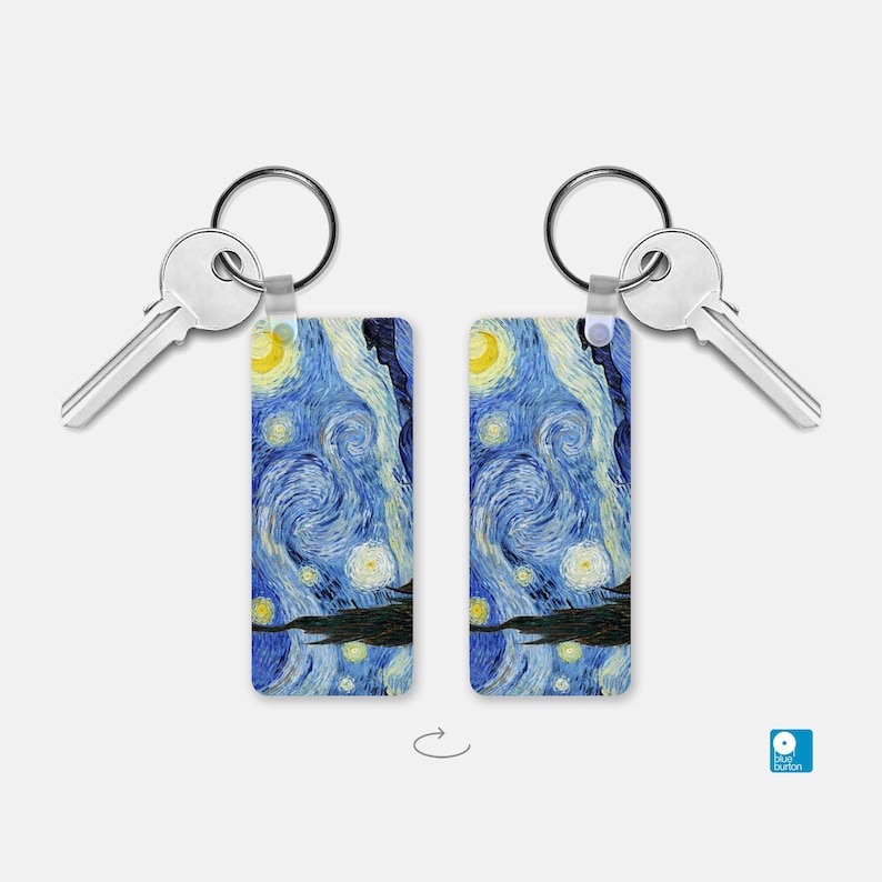 May include: A pair of silver keychains with a blue and yellow Starry Night painting design. The keychains are attached to silver keys.