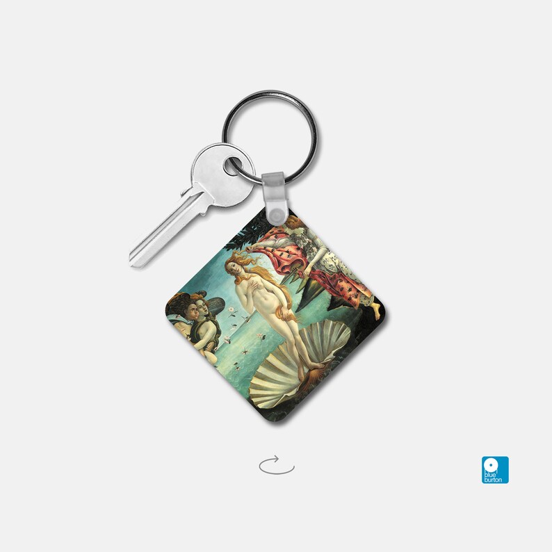 May include: A silver key chain with a square-shaped charm featuring a Renaissance-era painting of the birth of Venus. The painting depicts a nude woman standing on a seashell, with two figures flanking her.
