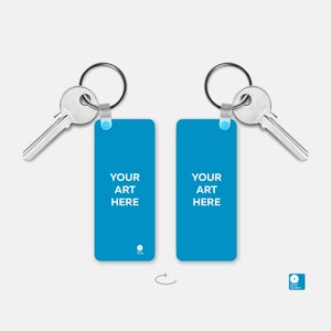 May include: Two blue rectangular keychains with silver key rings and keys. The keychains have the text "YOUR ART HERE" printed on them.