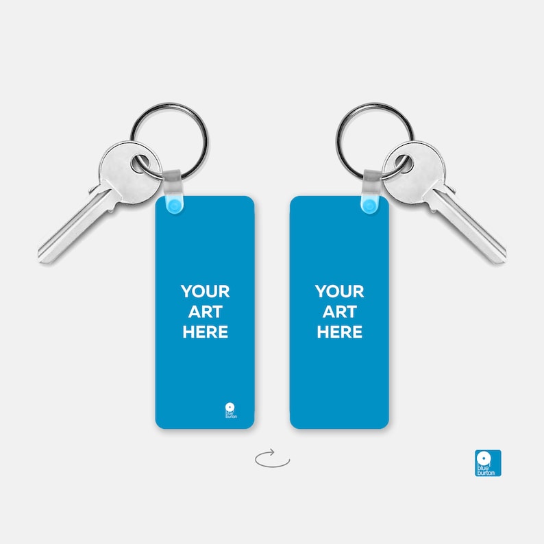 May include: Two blue rectangular keychains with silver key rings and keys. The keychains have the text "YOUR ART HERE" printed on them.