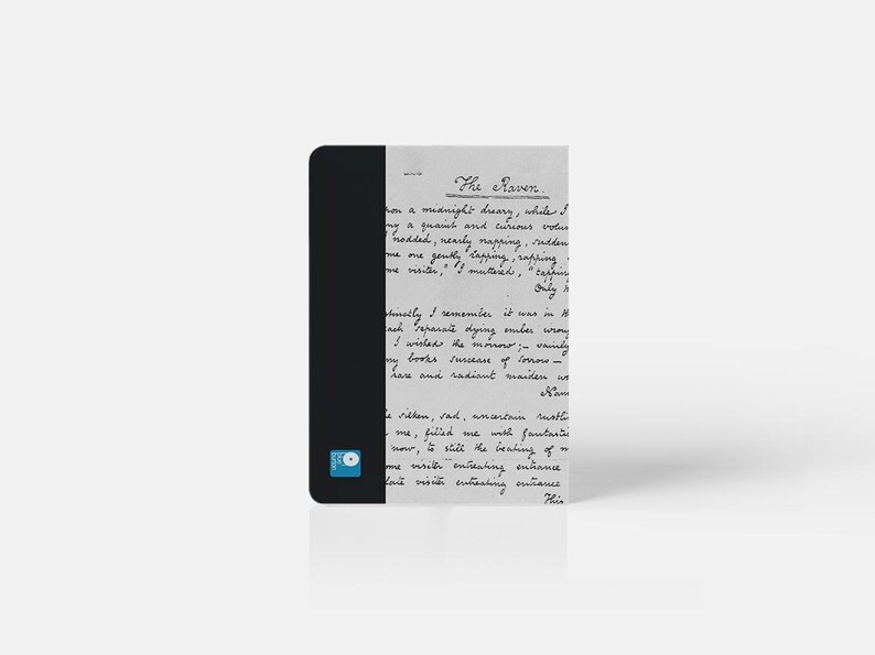 May include: A black and white notebook with a handwritten excerpt from "The Raven" by Edgar Allan Poe. The text is in cursive and includes the lines "on a midnight dreary, while I pondered, weak and weary, over many a quaint and curious volume of forgotten lore."
