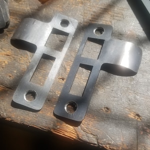 Mortise lock steel strikeplate right or left, laser cut with hand forged long radiused lip to protect door jamb millwork countersunk holes.
