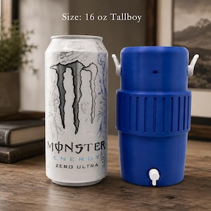 May include: A 16 oz tallboy Monster Energy Zero Ultra can with a white and silver design next to a blue plastic beverage cooler with a white spigot and two white side handles. The text on the can reads Monster Energy Zero Ultra.
