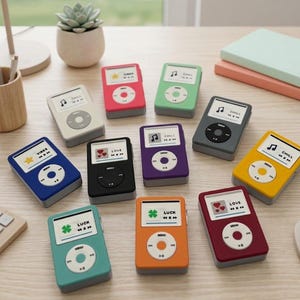 May include: A collection of colorful, retro-style music players in various colors, including red, blue, and green, are arranged on a wooden surface. Each player features a screen with icons and text, and a central control button. The overall aesthetic is playful and nostalgic.