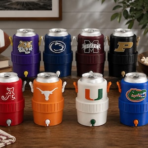 May include: A collection of eight cylindrical beverage coolers designed to hold standard cans, each featuring a unique collegiate sports logo. These plastic coolers include a top opening, side handles, and a small spigot at the base for dispensing.