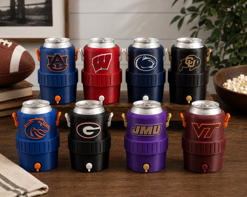May include: Eight beverage can coolers shaped like miniature water jugs, each featuring a different collegiate sports logo. The coolers are arranged in two rows and come in various colors including blue, red, black, purple, and maroon.