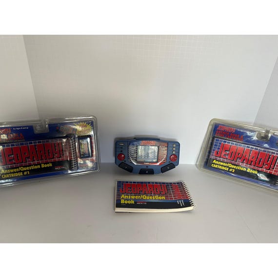 Tiger Electronics Jeopardy Handheld LCD Game Console W 3 Cartridges And Booklet