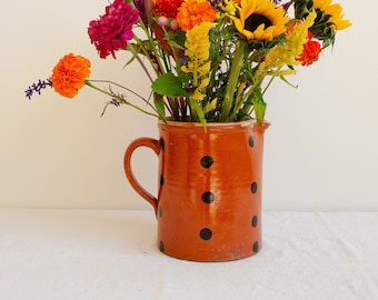 Antique polka dot glazed clay pitcher with handle