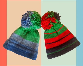 Hand knitted wool hats with big Pom in blue and red color scheme