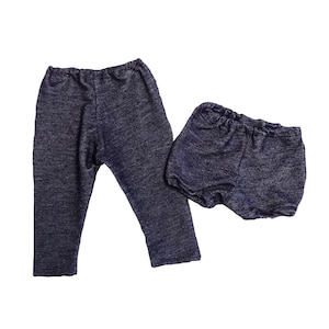 May include: A set of two-piece baby clothing in a dark blue fabric. The set includes a pair of long pants and a pair of bloomers. The fabric has a subtle textured appearance.