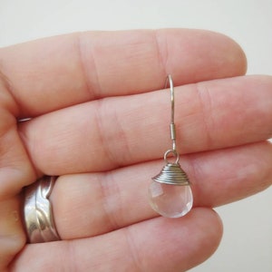 May include: A silver wire wrapped clear quartz crystal dangle earring.