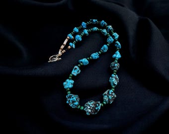 Women&#39;s Navajo inspired blue turquoise necklace with green turquoise spacer beads and penshell. 22 inches with pewter artisian toggle clasp.