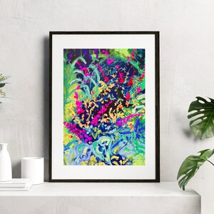 May include: Abstract painting of a colourful floral design with pink, blue, green, and yellow hues. The painting is framed in a black frame.