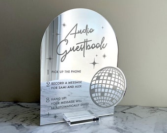 May include: A silver mirror with a disco ball design and the text "Audio Guestbook" with instructions to record a message for Sami and Alex.