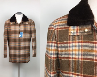 May include: A brown plaid jacket with a dark brown faux fur collar. The jacket features a button-down closure and a tag. The plaid pattern includes shades of brown, orange, red, and blue. The jacket is displayed on a mannequin.