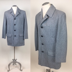 May include: A gray wool jacket with a notched collar, six black buttons, and two large flap pockets.