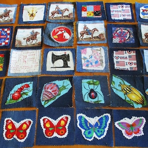 May include: A collection of thirty-four square denim fabric patches arranged in a grid. Each patch features a unique printed design, including cowboys on horses, insects like bees and butterflies, a sewing machine, and various patriotic American motifs.